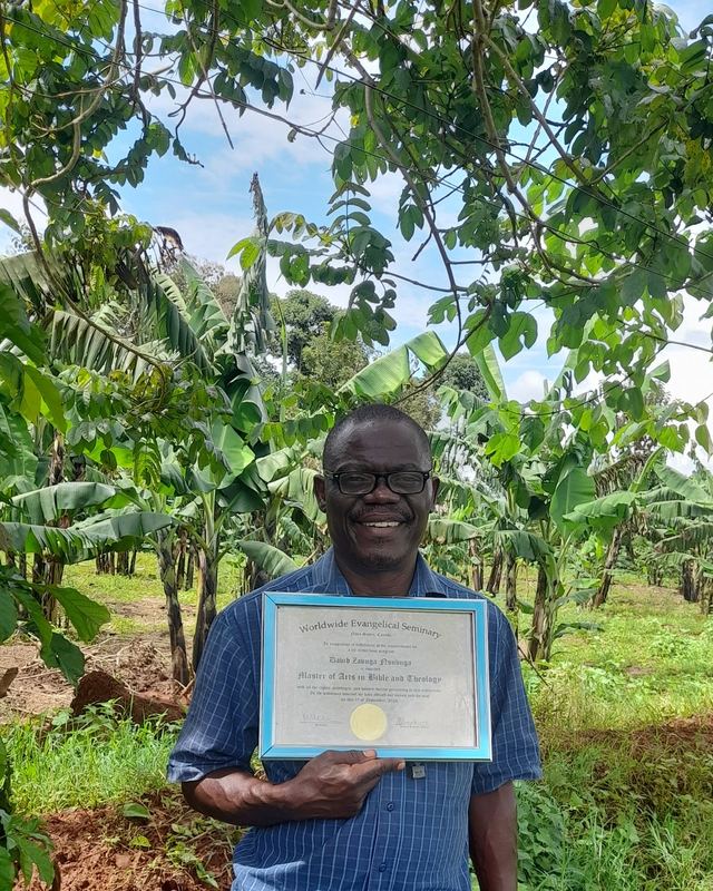 A graduate with his framed certificate