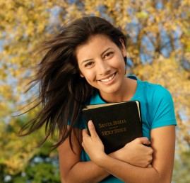 A student holding her Bible